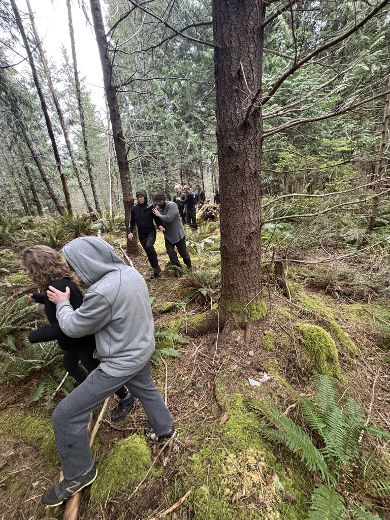 Partners training on uneven forest ground