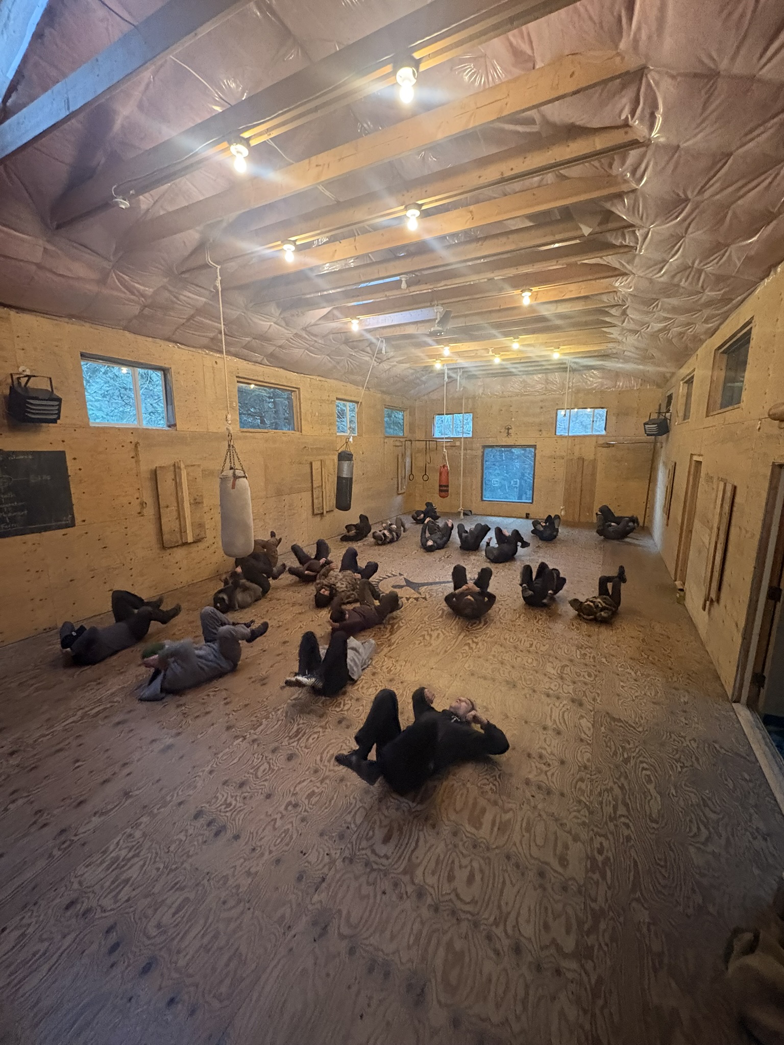 A group practising ground movement on the dojo floor
